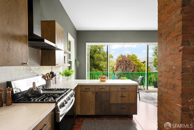 2013-2015 Golden Gate Ave, San Francisco, CA 94115 - kitchen with wall chimney exhaust hood, stainless steel gas range oven, light countertops, and backsplash
