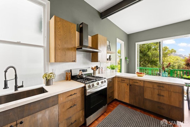 2013-2015 Golden Gate Ave, San Francisco, CA 94115 - kitchen featuring wall chimney exhaust hood, stainless steel range with gas cooktop, tasteful backsplash, beamed ceiling, and brown cabinetry