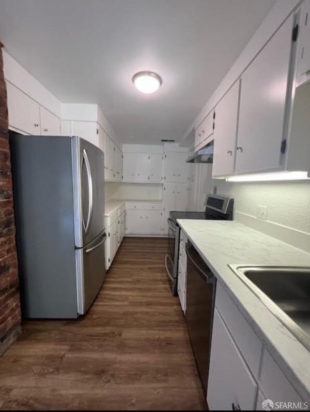 2013-2015 Golden Gate Ave, San Francisco, CA 94115 - kitchen featuring stainless steel appliances, under cabinet range hood, white cabinetry, dark wood-style flooring, and light countertops