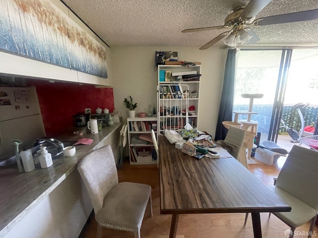 dining room with ceiling fan and a textured ceiling