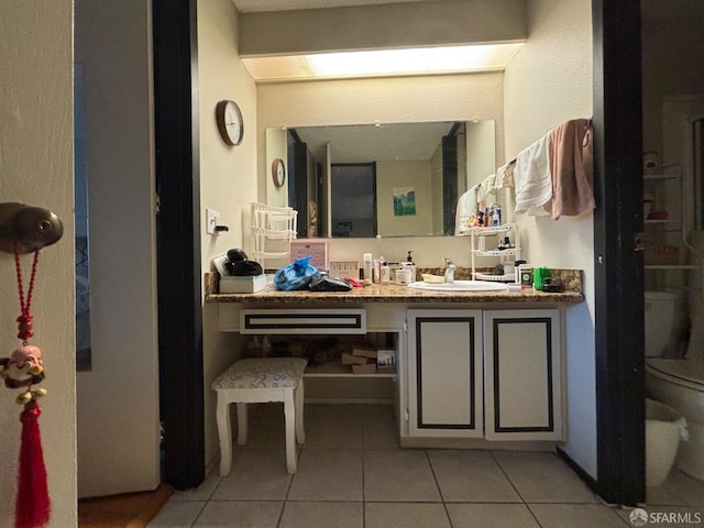 bathroom featuring tile patterned floors, vanity, and toilet