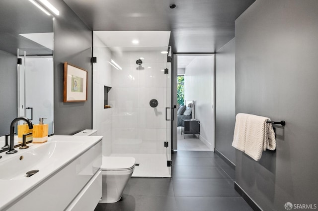 bathroom with a stall shower, vanity, toilet, and baseboards