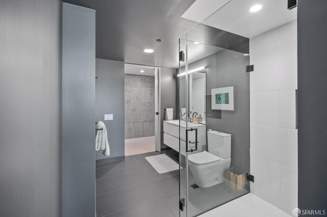 full bathroom featuring a walk in shower, tile walls, toilet, and vanity