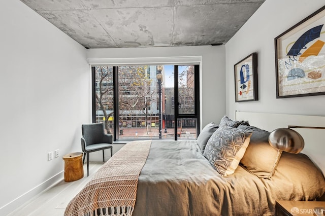 bedroom featuring baseboards and wood finished floors