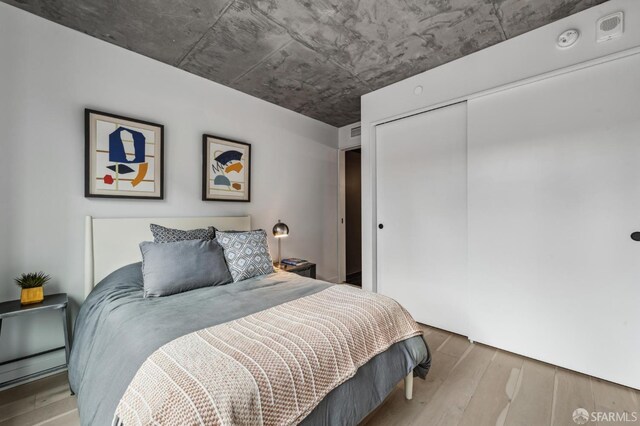 bedroom featuring a closet and wood finished floors