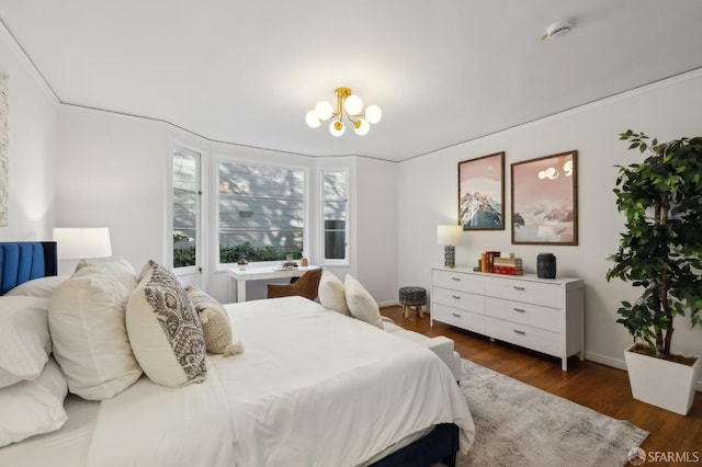 bedroom featuring an inviting chandelier and dark hardwood / wood-style flooring