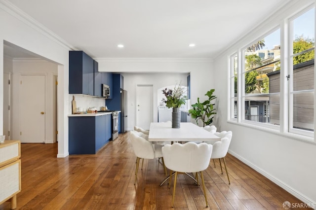 dining room featuring dark hardwood / wood-style flooring and ornamental molding