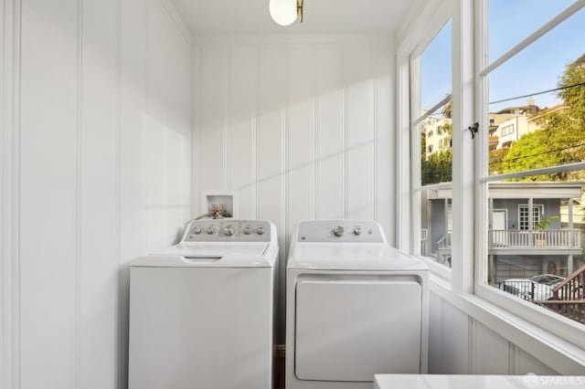 laundry room with washing machine and dryer and crown molding