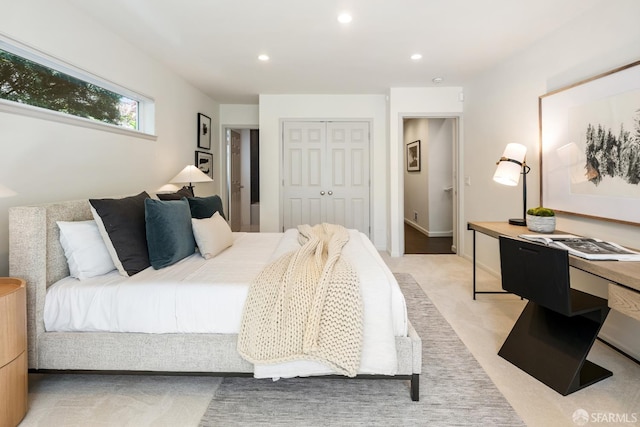 bedroom featuring a closet, recessed lighting, and light colored carpet