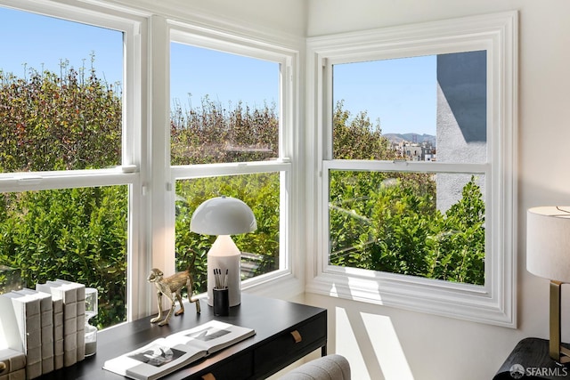 sunroom / solarium featuring healthy amount of natural light