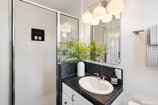 bathroom with a stall shower and vanity