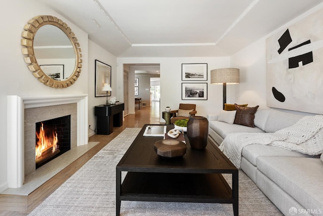 living area with a premium fireplace and wood finished floors
