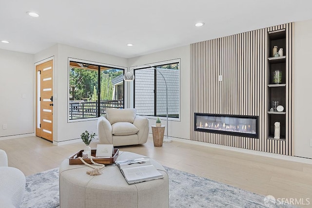 1098 Siler Pl, Berkeley, CA 94705 - living area featuring wood finished floors, a glass covered fireplace, healthy amount of natural light, and recessed lighting