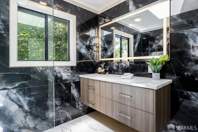 1098 Siler Pl, Berkeley, CA 94705 - full bath featuring tile walls, marble tiled flooring, vanity, and healthy amount of natural light