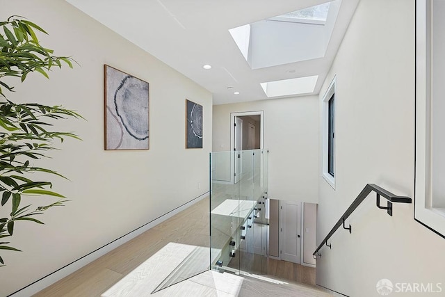 1098 Siler Pl, Berkeley, CA 94705 - corridor featuring a skylight, wood finished floors, baseboards, plenty of natural light, and recessed lighting