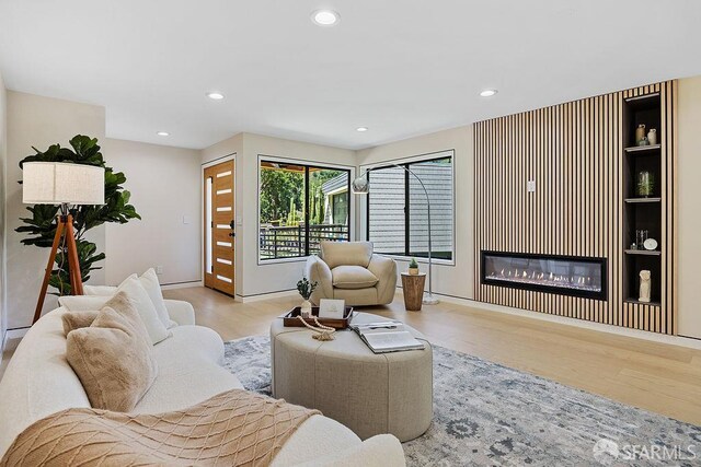 1098 Siler Pl, Berkeley, CA 94705 - living area featuring wood finished floors, a glass covered fireplace, and recessed lighting