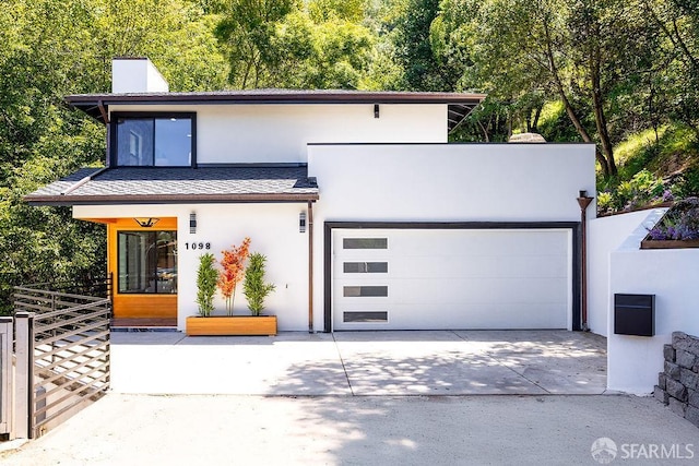 1098 Siler Pl, Berkeley, CA 94705 - modern home with stucco siding, concrete driveway, a chimney, and an attached garage