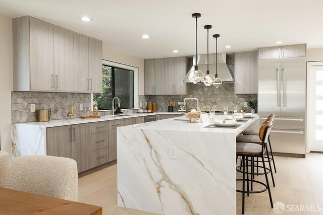 1098 Siler Pl, Berkeley, CA 94705 - kitchen with wall chimney exhaust hood, built in refrigerator, a center island, light wood finished floors, and recessed lighting