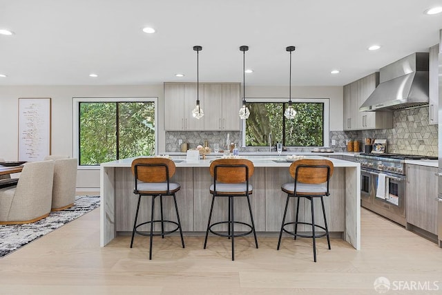 1098 Siler Pl, Berkeley, CA 94705 - kitchen with wall chimney range hood, range with two ovens, light countertops, backsplash, and a large island