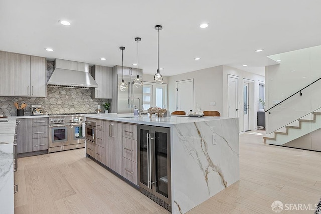 1098 Siler Pl, Berkeley, CA 94705 - kitchen with modern cabinets, wall chimney exhaust hood, beverage cooler, double oven range, and light wood finished floors