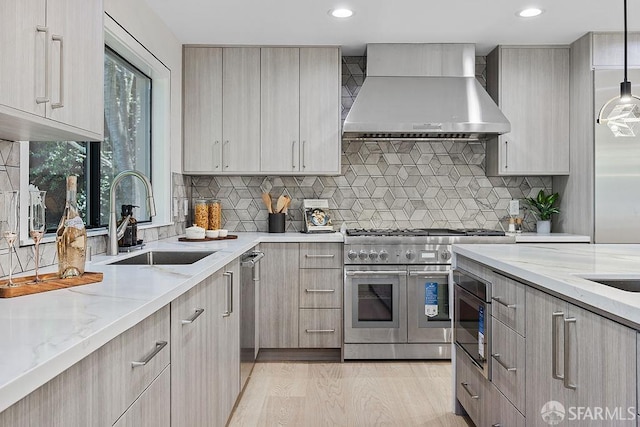 1098 Siler Pl, Berkeley, CA 94705 - kitchen featuring wall chimney range hood, appliances with stainless steel finishes, a sink, light stone counters, and recessed lighting