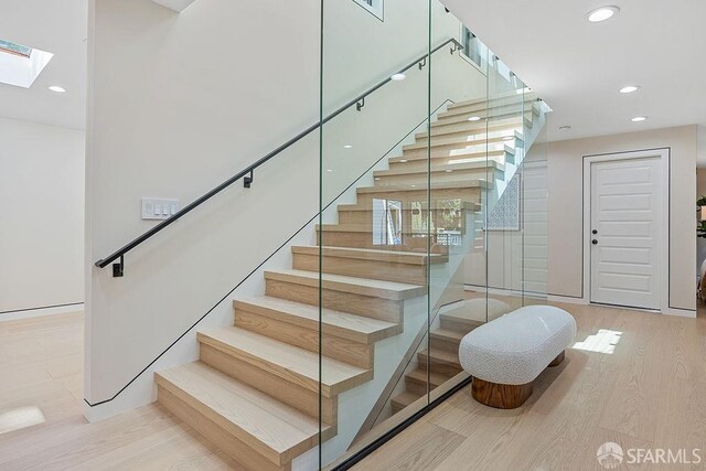 1098 Siler Pl, Berkeley, CA 94705 - stairway with recessed lighting, a skylight, and wood finished floors
