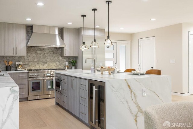 1098 Siler Pl, Berkeley, CA 94705 - kitchen with wall chimney range hood, range with two ovens, wine cooler, modern cabinets, and recessed lighting