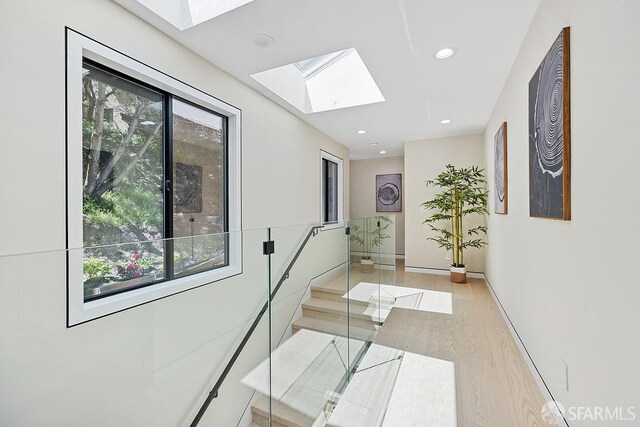 1098 Siler Pl, Berkeley, CA 94705 - hallway with a skylight, recessed lighting, light wood finished floors, and baseboards