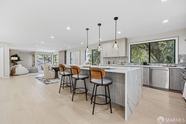 1098 Siler Pl, Berkeley, CA 94705 - kitchen with modern cabinets, dishwasher, light wood-type flooring, a center island with sink, and light countertops