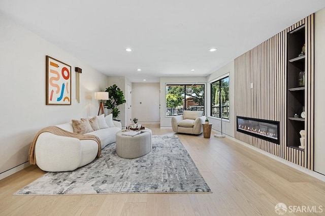 1098 Siler Pl, Berkeley, CA 94705 - living area featuring wood finished floors, a glass covered fireplace, recessed lighting, and baseboards
