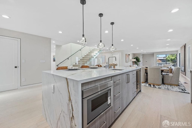 1098 Siler Pl, Berkeley, CA 94705 - kitchen with a sink, stainless steel microwave, modern cabinets, open floor plan, and recessed lighting