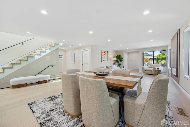 1098 Siler Pl, Berkeley, CA 94705 - dining area with stairs, recessed lighting, light wood-style flooring, and baseboards