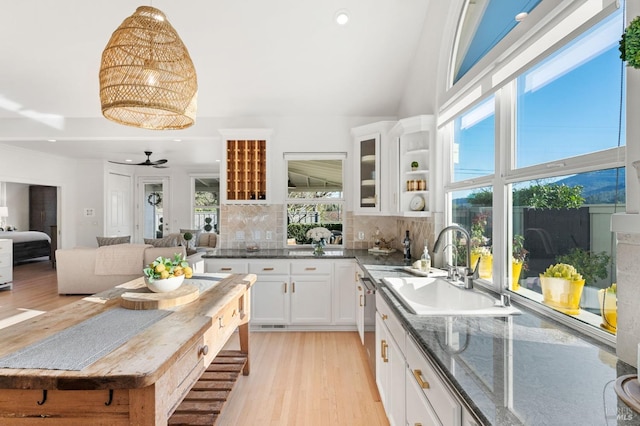 1316 Sulphur Springs Ave, Saint Helena, CA 94574 - kitchen with light wood-style flooring, a sink, glass insert cabinets, white cabinetry, and decorative backsplash