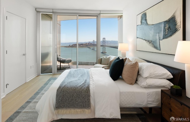 301 Main St Unit 34B, San Francisco, CA 94105 - bedroom with access to outside, expansive windows, wood finished floors, and a water view
