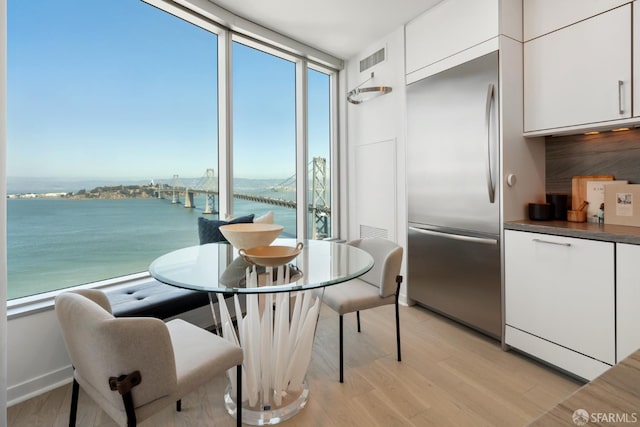301 Main St Unit 34B, San Francisco, CA 94105 - dining area featuring a water view, plenty of natural light, light wood-type flooring, and expansive windows