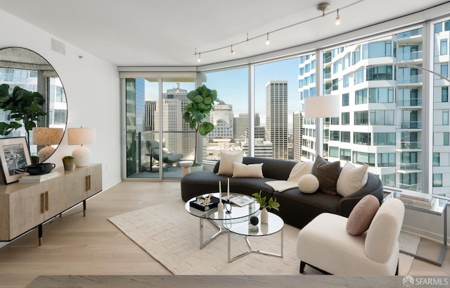 301 Main St Unit 34B, San Francisco, CA 94105 - living room featuring plenty of natural light, a view of city, wood finished floors, and a wall of windows