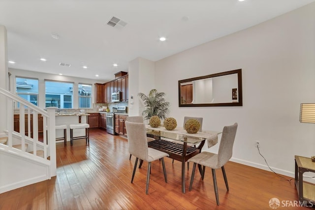 2702 Urbino Ct, San Jose, CA 95111 - dining room featuring wood finished floors, recessed lighting, baseboards, and stairs