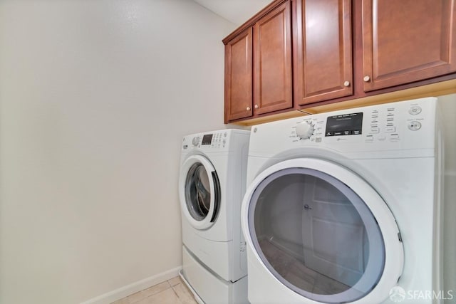 2702 Urbino Ct, San Jose, CA 95111 - laundry area with cabinet space, washing machine and dryer, light tile patterned floors, and baseboards