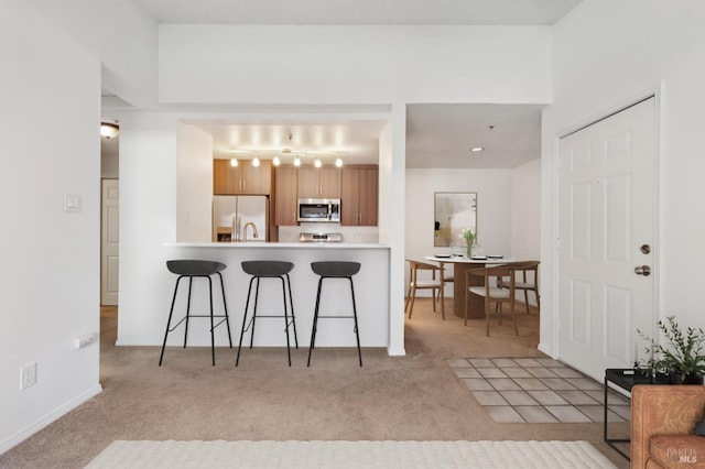 1201 Glen Cove Pkwy Unit 514, Vallejo, CA 94591 - kitchen featuring stainless steel appliances, carpet floors, a kitchen bar, light countertops, and a peninsula