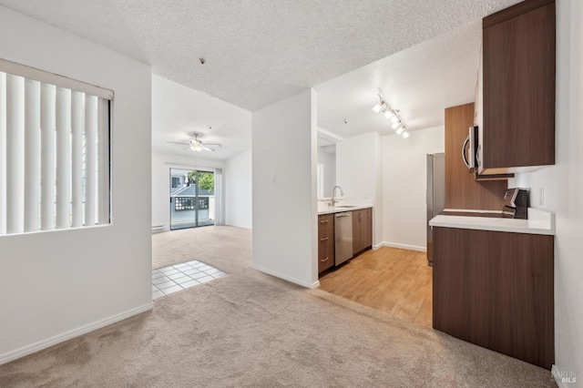 1201 Glen Cove Pkwy Unit 514, Vallejo, CA 94591 - kitchen with appliances with stainless steel finishes, light carpet, a sink, light countertops, and a textured ceiling