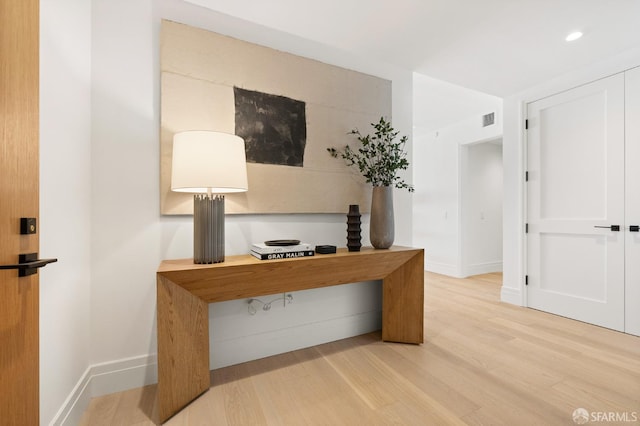 unfurnished office featuring recessed lighting, visible vents, light wood-style flooring, and baseboards