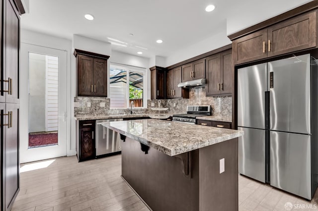8534 Jetty Way, Newark, CA 94560 - kitchen featuring appliances with stainless steel finishes, dark brown cabinetry, decorative backsplash, and recessed lighting