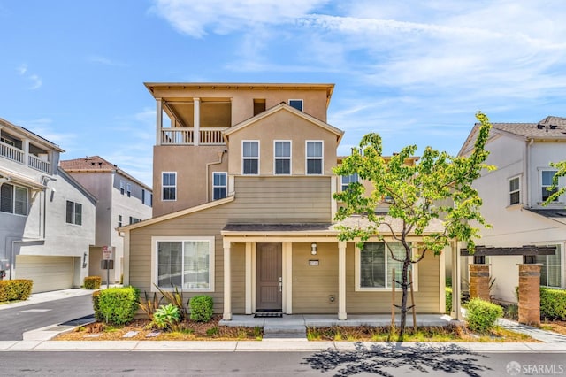 8534 Jetty Way, Newark, CA 94560 - townhome / multi-family property with covered porch, driveway, and an attached garage