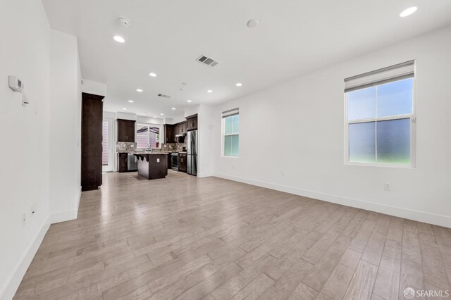8534 Jetty Way, Newark, CA 94560 - unfurnished living room with recessed lighting, light wood-style flooring, and baseboards