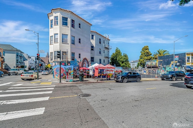 3230-3236 24th St, San Francisco, CA 94110 - view of asphalt street featuring street lighting, sidewalks, and curbs