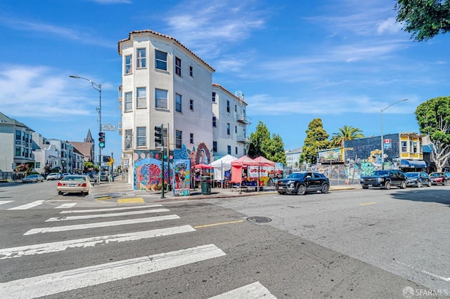 3230-3236 24th St, San Francisco, CA 94110 - view of asphalt street with street lighting, curbs, sidewalks, and traffic signs