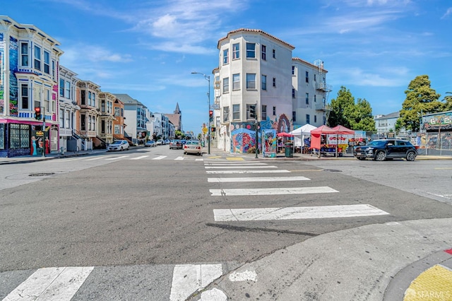 3230-3236 24th St, San Francisco, CA 94110 - view of asphalt street featuring street lights, sidewalks, curbs, and a residential view