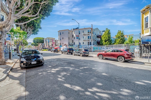3230-3236 24th St, San Francisco, CA 94110 - view of asphalt road with street lighting, sidewalks, and curbs