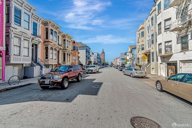 3230-3236 24th St, San Francisco, CA 94110 - view of asphalt street featuring a residential view, sidewalks, street lights, and traffic signs