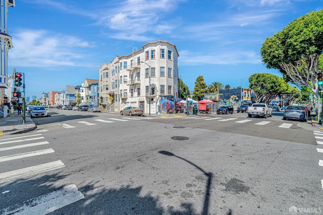 3230-3236 24th St, San Francisco, CA 94110 - view of asphalt street with traffic lights, street lights, sidewalks, and curbs
